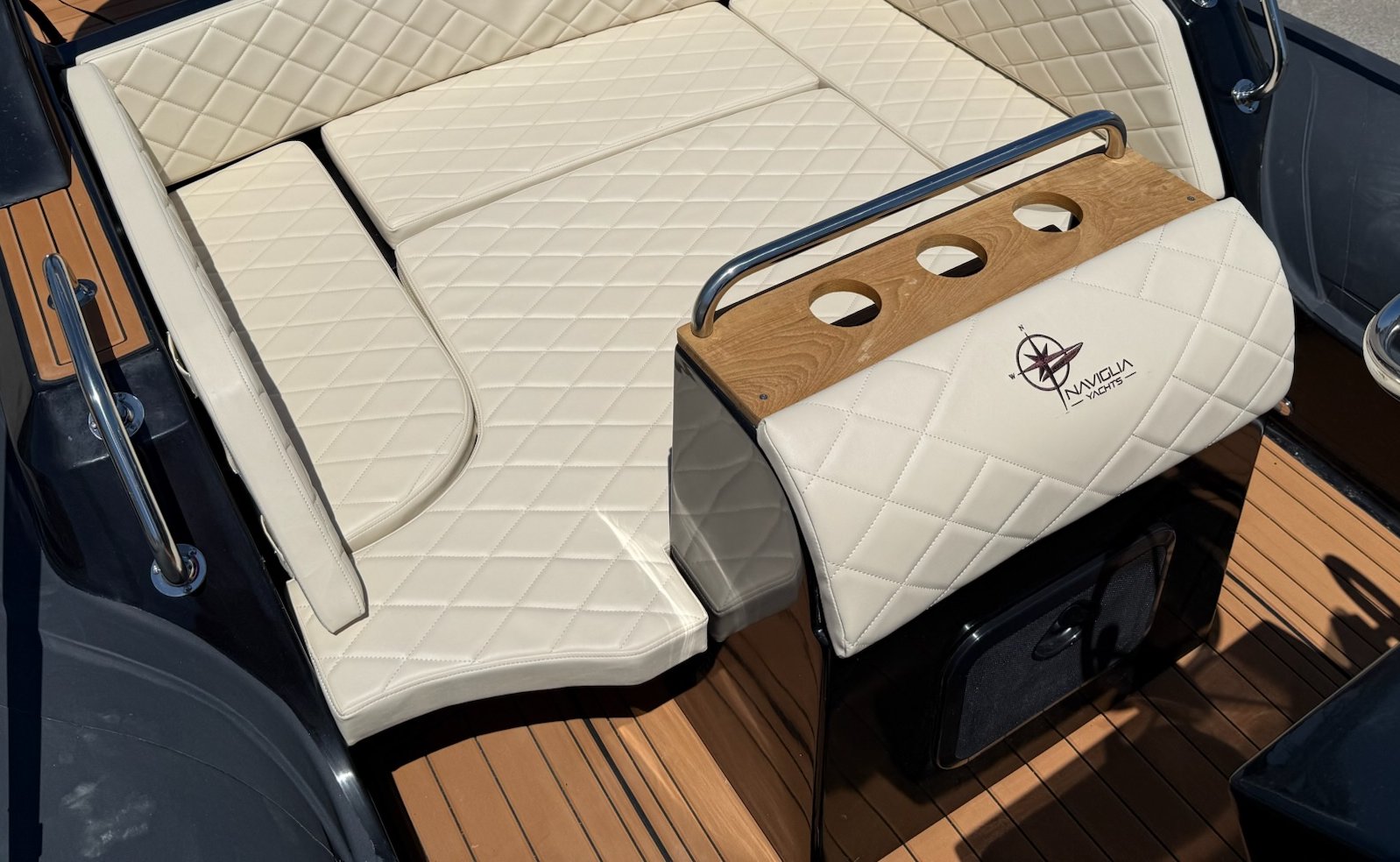 NAVY 7.60 aft area converted into a sun pad, cream diamond-quilted cushions and logo unit