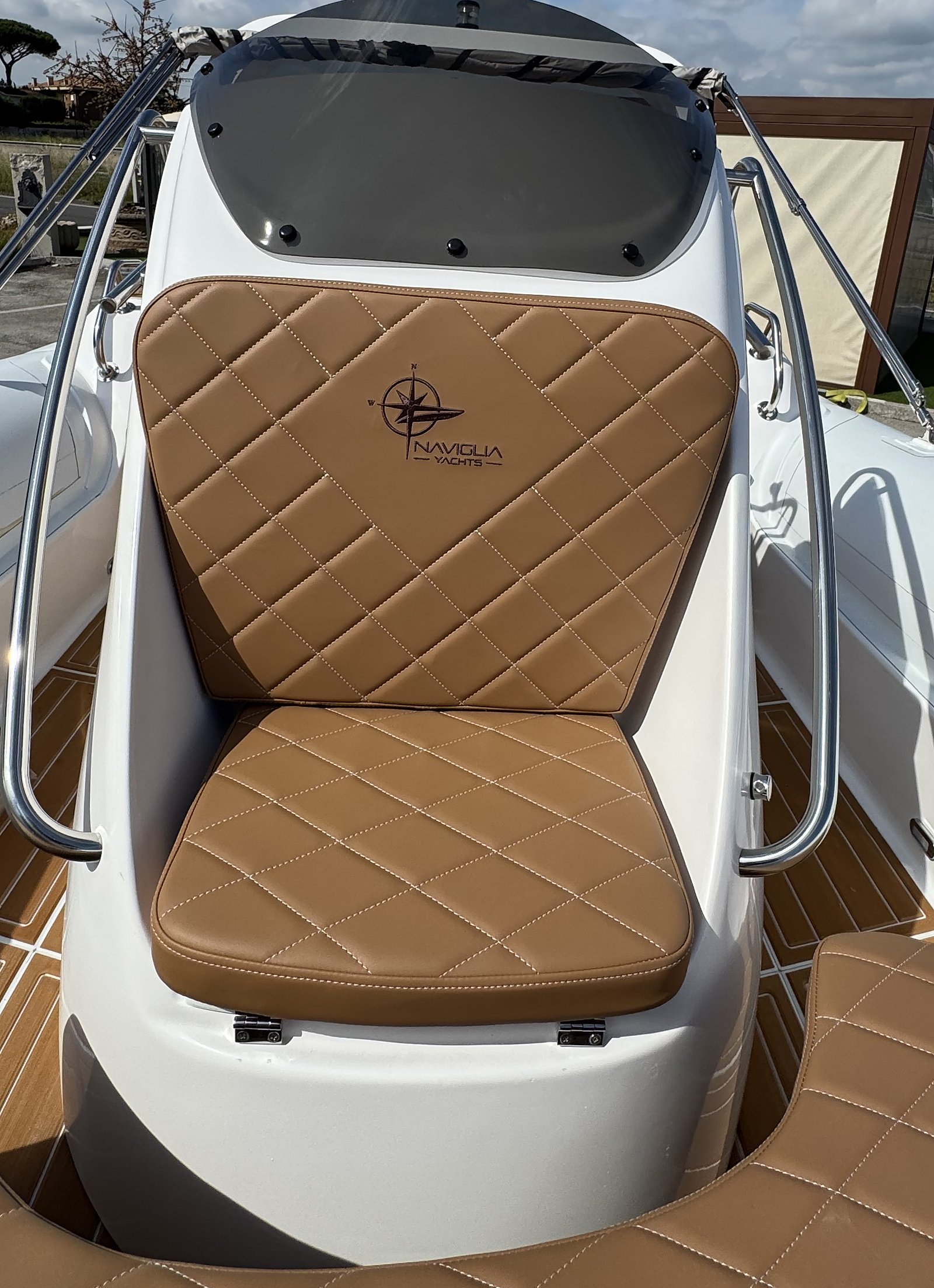 Tobacco console seat with Naviglia Yachts logo on the white NAVY 7.60