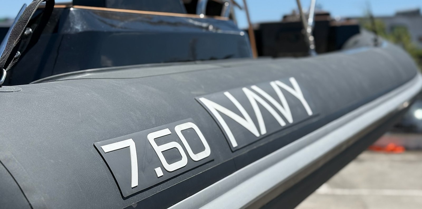 Raised 7.60 NAVY lettering on the anthracite tube, light grey rubbing strake running diagonally