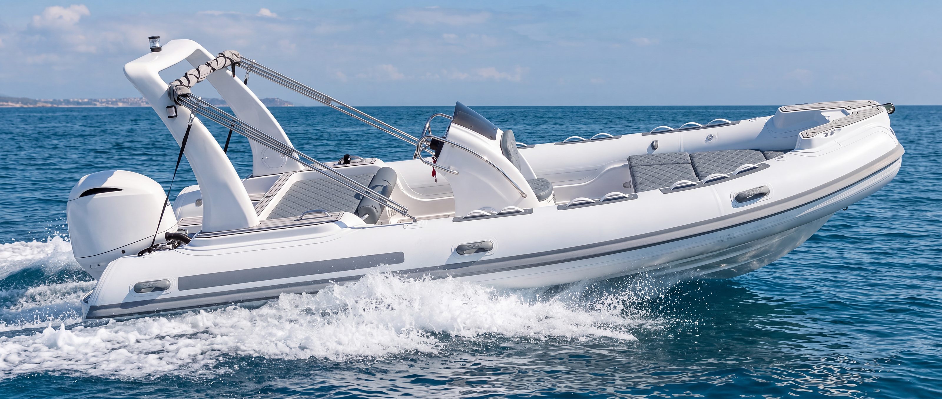 Naviglia vision: the white NAVY 6.00 planing, seen in profile, with the grey stripe on the tube and the white outboard