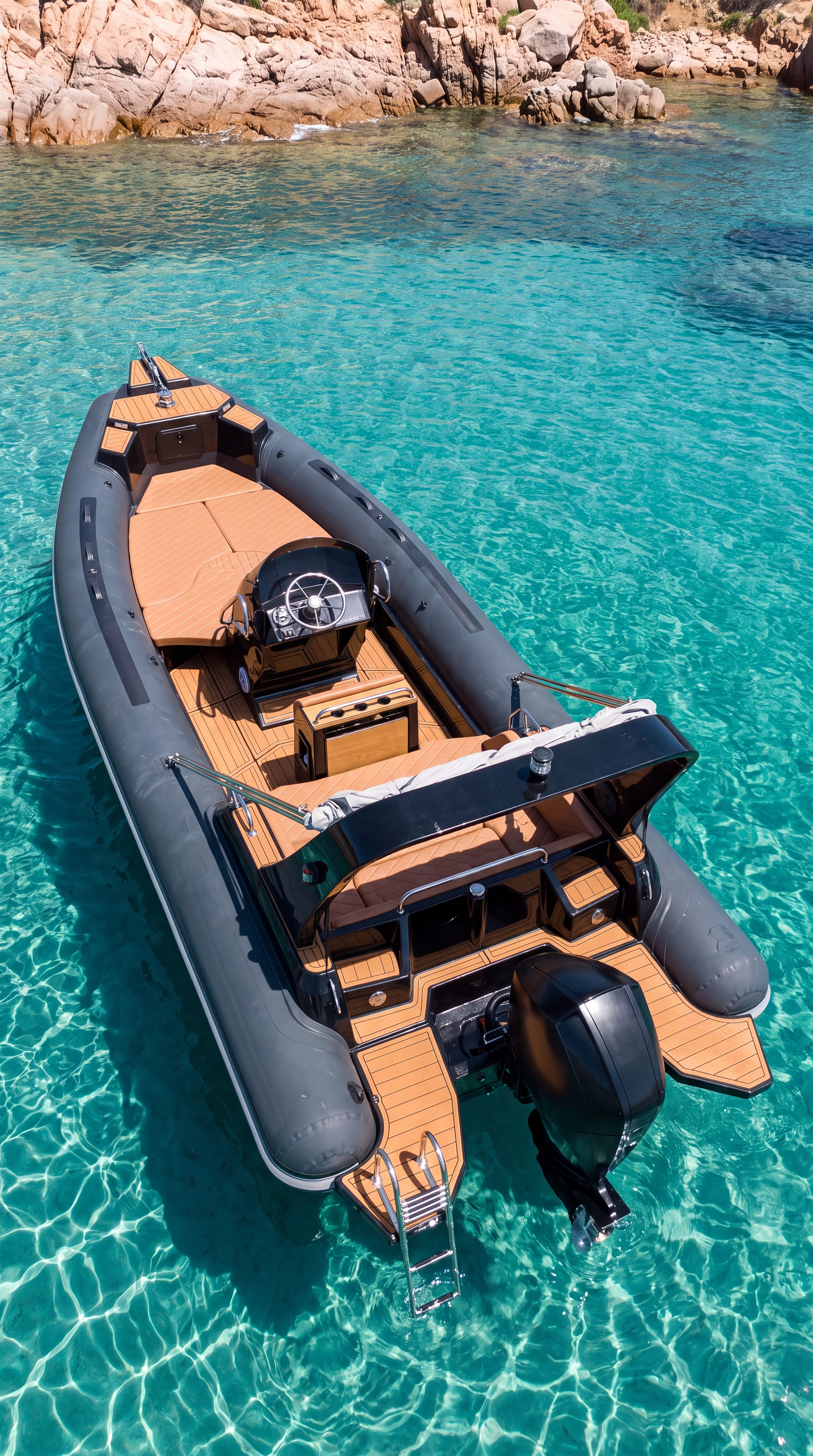 Naviglia vision: the anthracite NAVY 7.60 at anchor on turquoise water, seen from astern and above