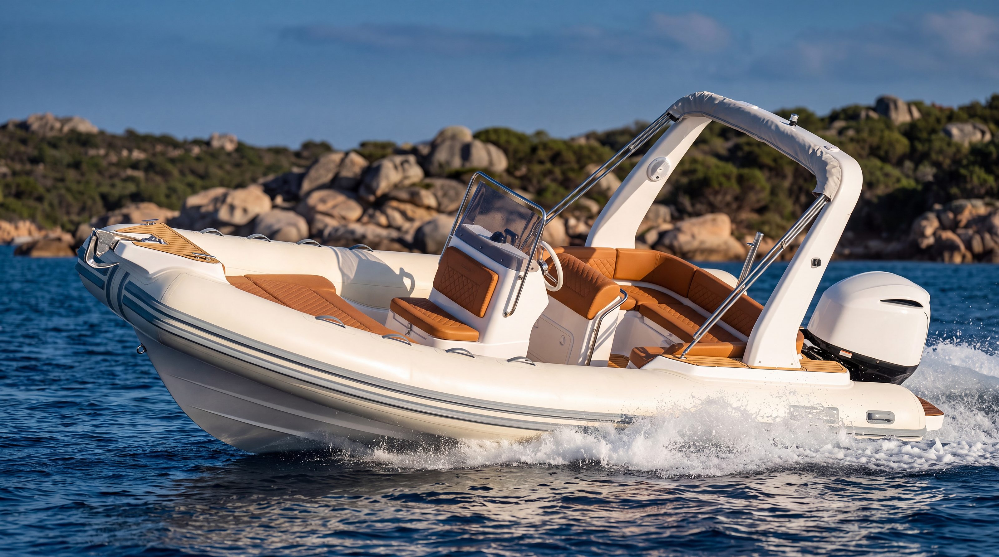 Naviglia vision: the white NAVY 7.60 under way, three-quarters from the bow, off a granite coast