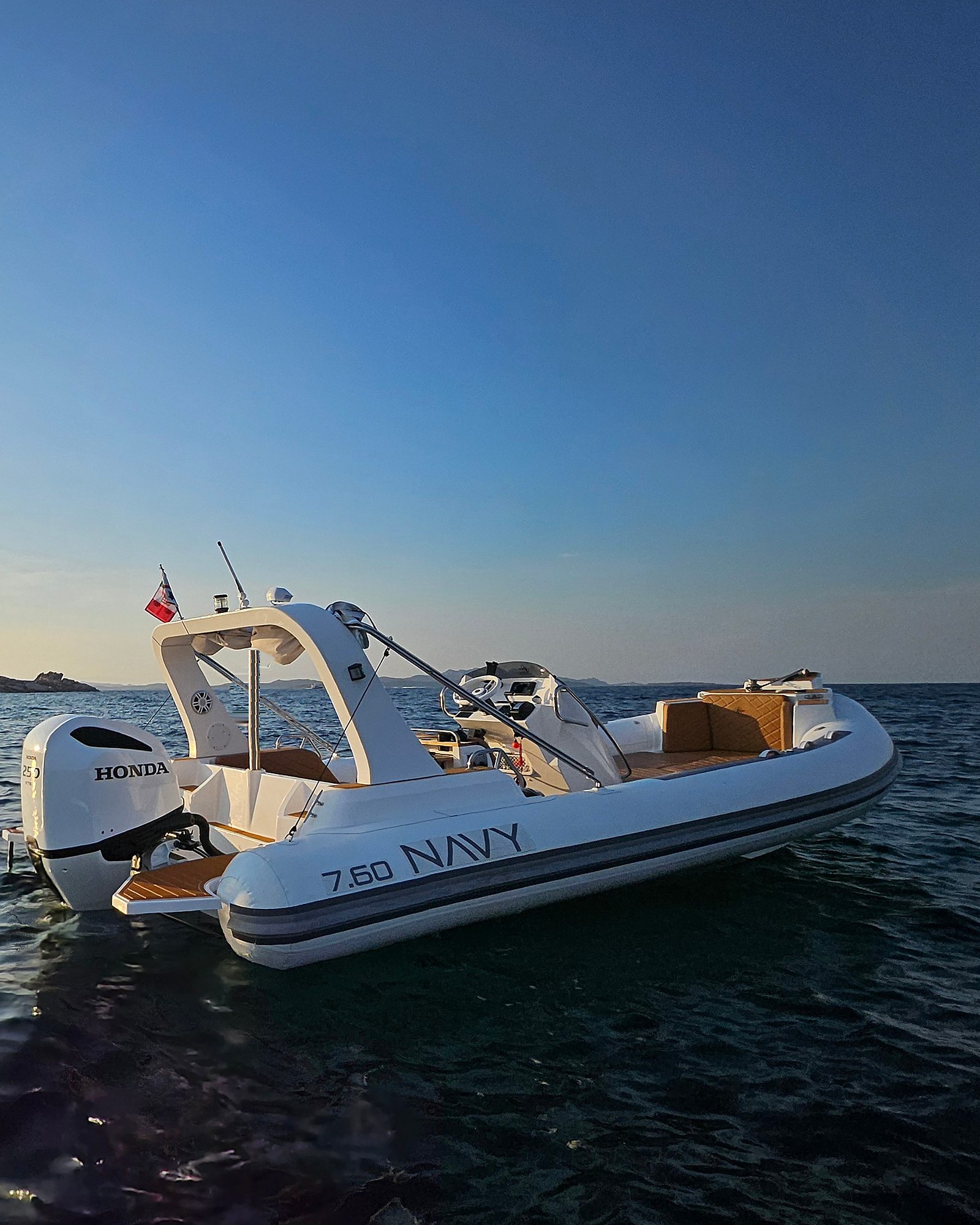 NAVY 7.60 at sunset seen from astern, lettering on the tube under a wide blue sky