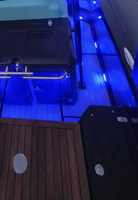Photograph from the yard, detail: the cockpit of the NAVY 9.50 Cabin seen from above in the evening, with blue lights in the decking
