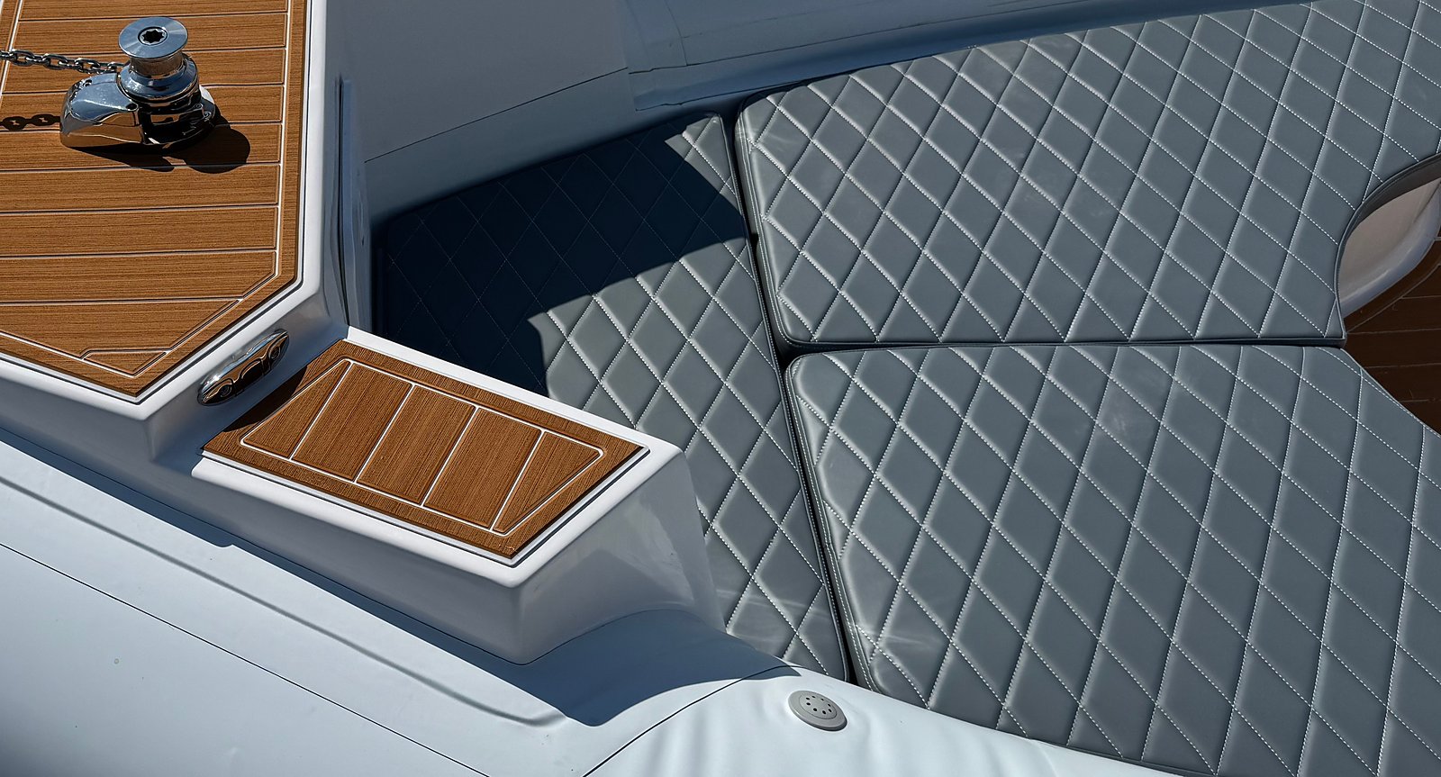 Prua del NAVY 7.60 bianco: verricello inox, gradini effetto teak e prendisole grigio trapuntato