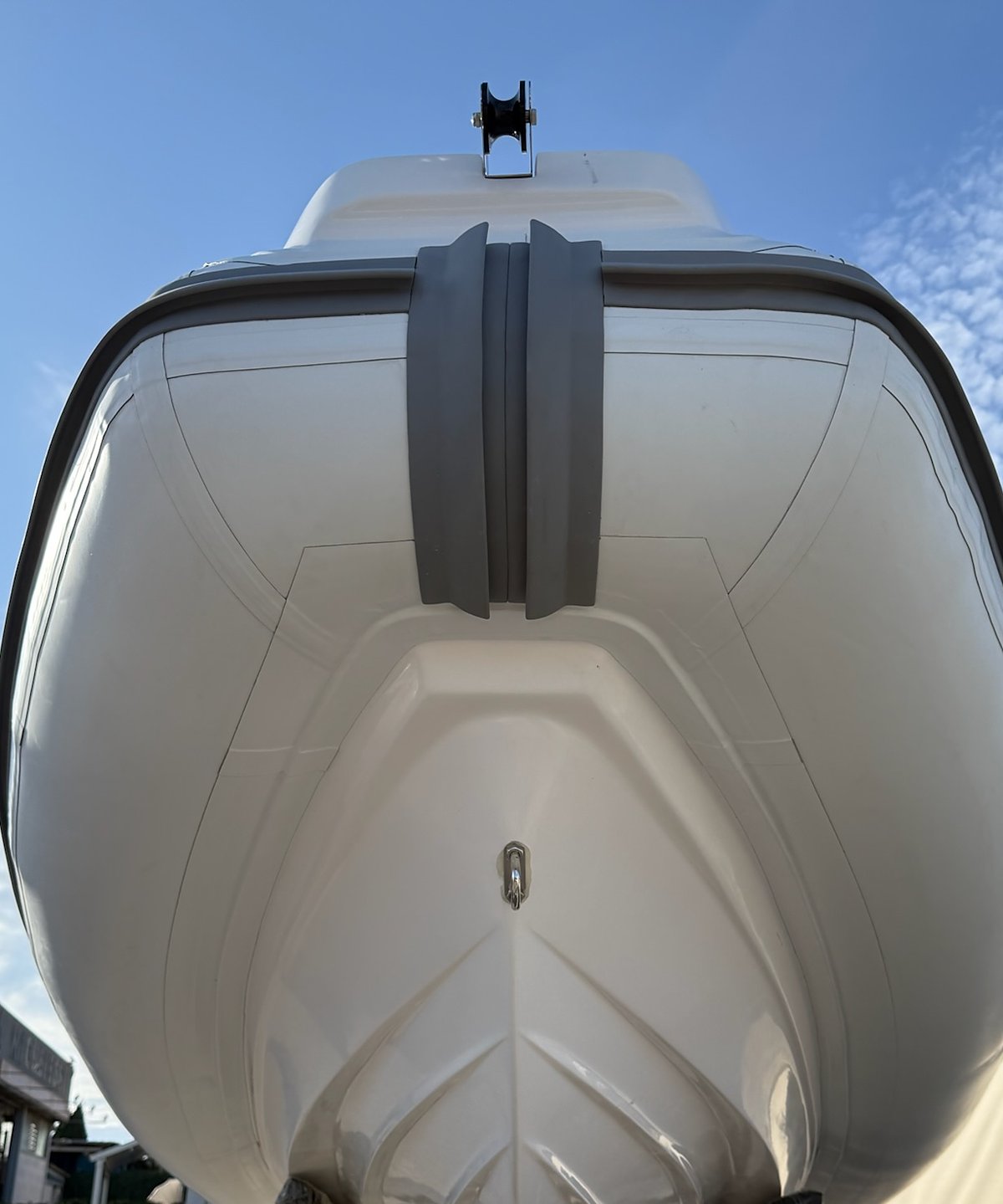 Deep-V hull of the NAVY 6.00 seen from below the bow, spray rails and grey fender